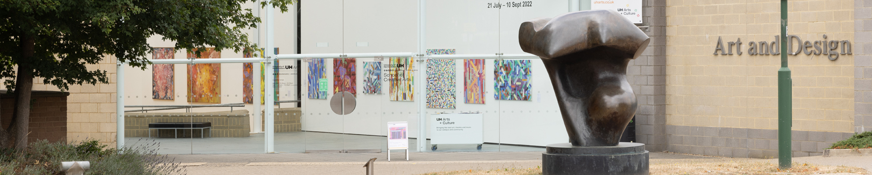 Image of gallery exterior with bronze abstract sculpture in front