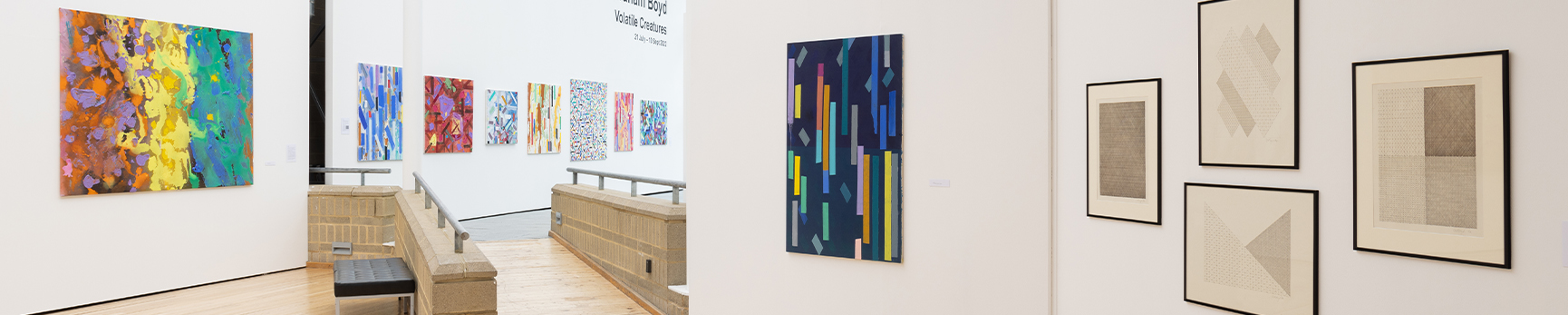 Installation view of large scale colourful abstract paintings in a white gallery space.